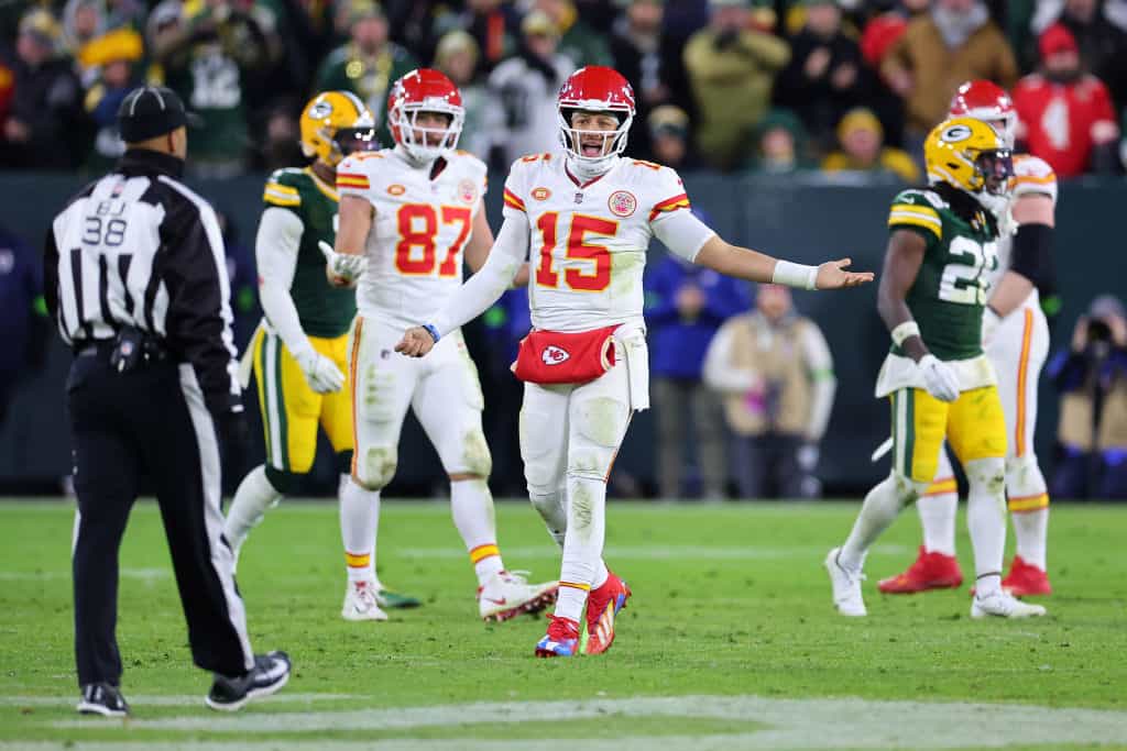 Patrick Mahomes #15 of the Kansas City Chiefs looks to back judge Greg Yette #38 during a game against the Green Bay Packers at Lambeau Field on December 03, 2023 in Green Bay, Wisconsin. The Packers defeated the Chiefs 27-19.