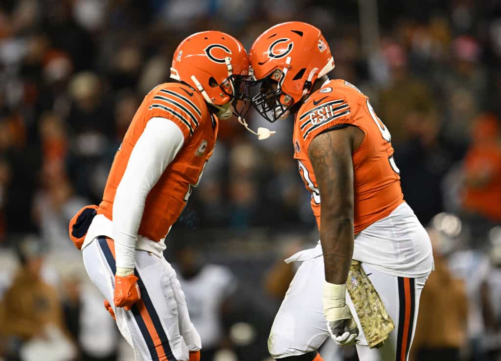Justin Jones #93 of the Chicago Bears celebrates with Eddie Jackson #4 after a sack during the first half at Soldier Field on November 09, 2023 in Chicago, Illinois.