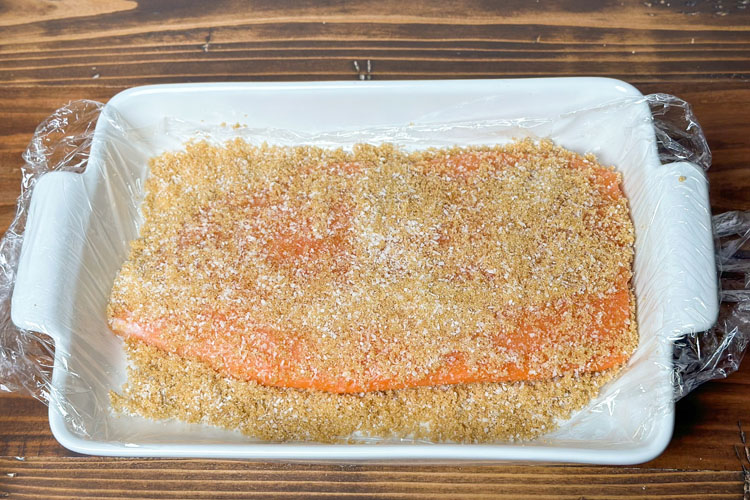 fresh salmon filet with dry cure all over it