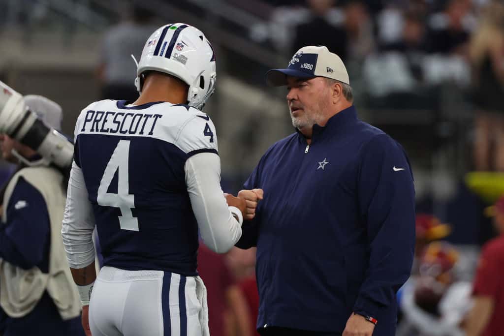 Head coach Mike McCarthy of the Dallas Cowboys interacts with Dak Prescott #4 of the Dallas Cowboys prior to the game against the Washington Commanders at AT&T Stadium on November 23, 2023 in Arlington, Texas.