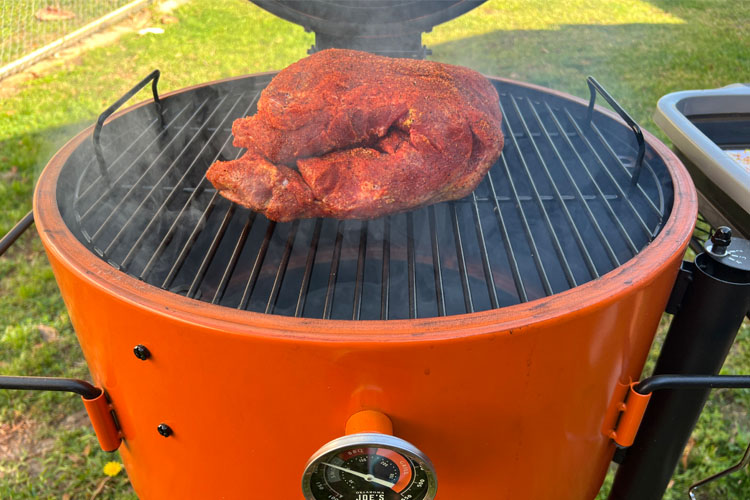 pork butt fat side down on a drum smoker