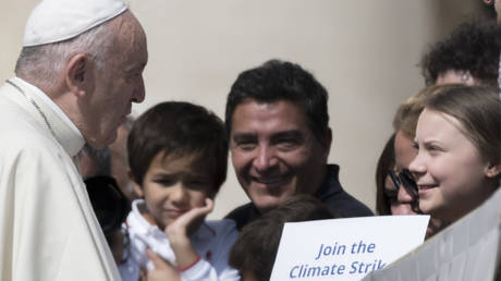 Pope Francis greets Swedish teenage environmental activist Greta Thunberg, right, during his weekly general audience in St. Peter's Square, at the Vatican, Wednesday, April 17, 2019