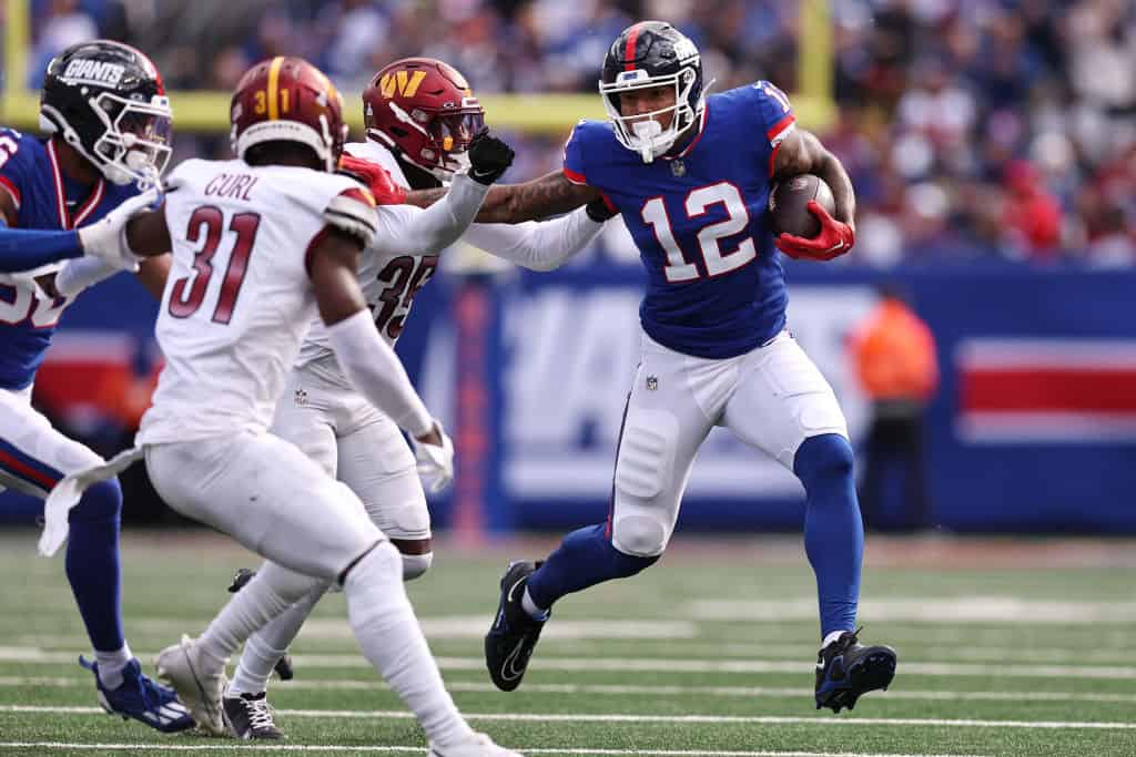 Darren Waller #12 of the New York Giants carries the ball against the Washington Commanders during the first half of the game at MetLife Stadium on October 22, 2023 in East Rutherford, New Jersey.