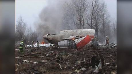 FILE PHOTO: A firefighter walks near the crash site where Polish President Lech Kaczynski's plane crashed near Smolensk, Russia, April 10, 2010