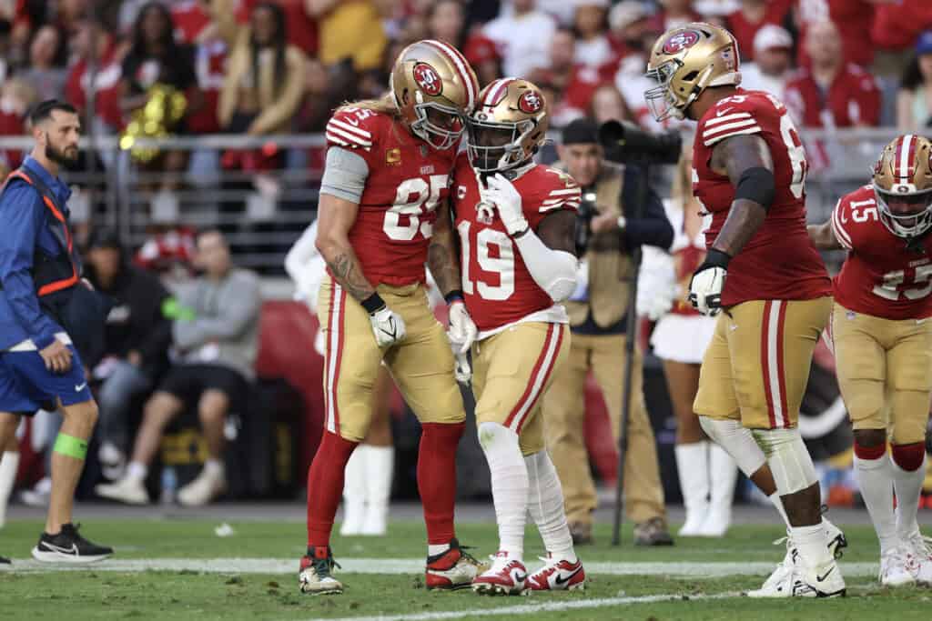 GLENDALE, ARIZONA - DECEMBER 17: Deebo Samuel #19 of the San Francisco 49ers and George Kittle #85 of the San Francisco 49ers react during the fourth quarter of a game against the Arizona Cardinals at State Farm Stadium on December 17, 2023 in Glendale, Arizona. 