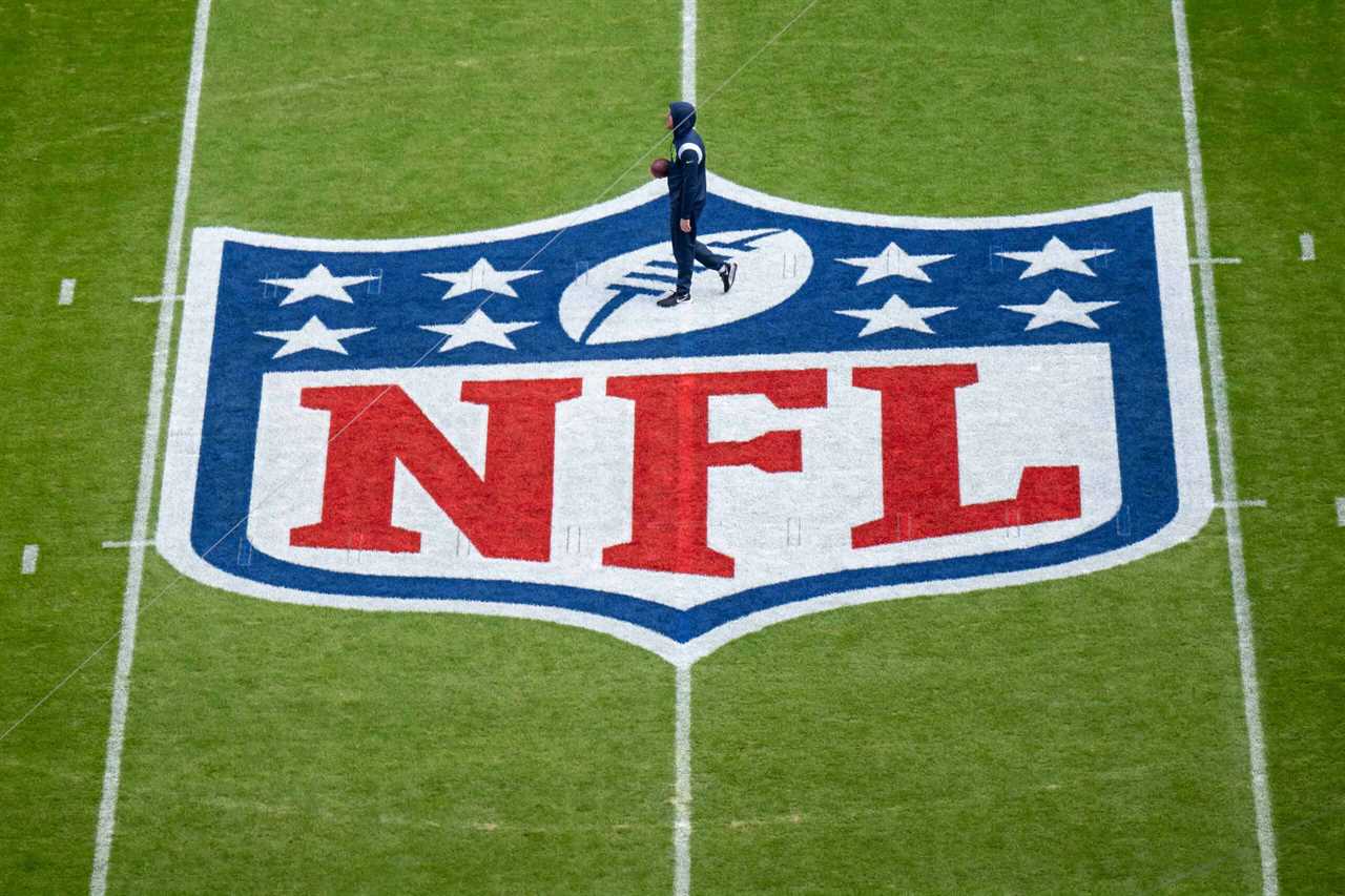A player warms up next to the NFL logo painted on the field prior to the NFL match between Seattle Seahawks and Tampa Bay Buccaneers at Allianz Arena on November 13, 2022 in Munich, Germany.