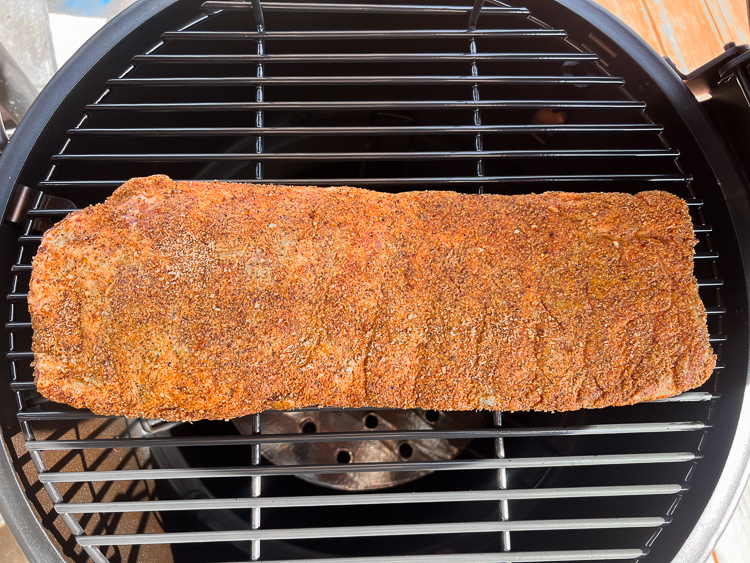 seasoned raw ribs on the smoker