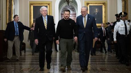 FILE PHOTO: Senate Minority Leader Mitch McConnell (L), Ukrainian President Vladimir Zelensky (C) and Senate Majority Leader Chuck Schumer (R).