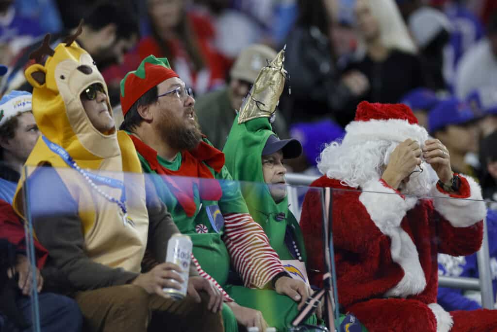 INGLEWOOD, CALIFORNIA - DECEMBER 23: Fans in festive attire look on during the game between the Buffalo Bills and the Los Angeles Chargers at SoFi Stadium on December 23, 2023 in Inglewood, California. 