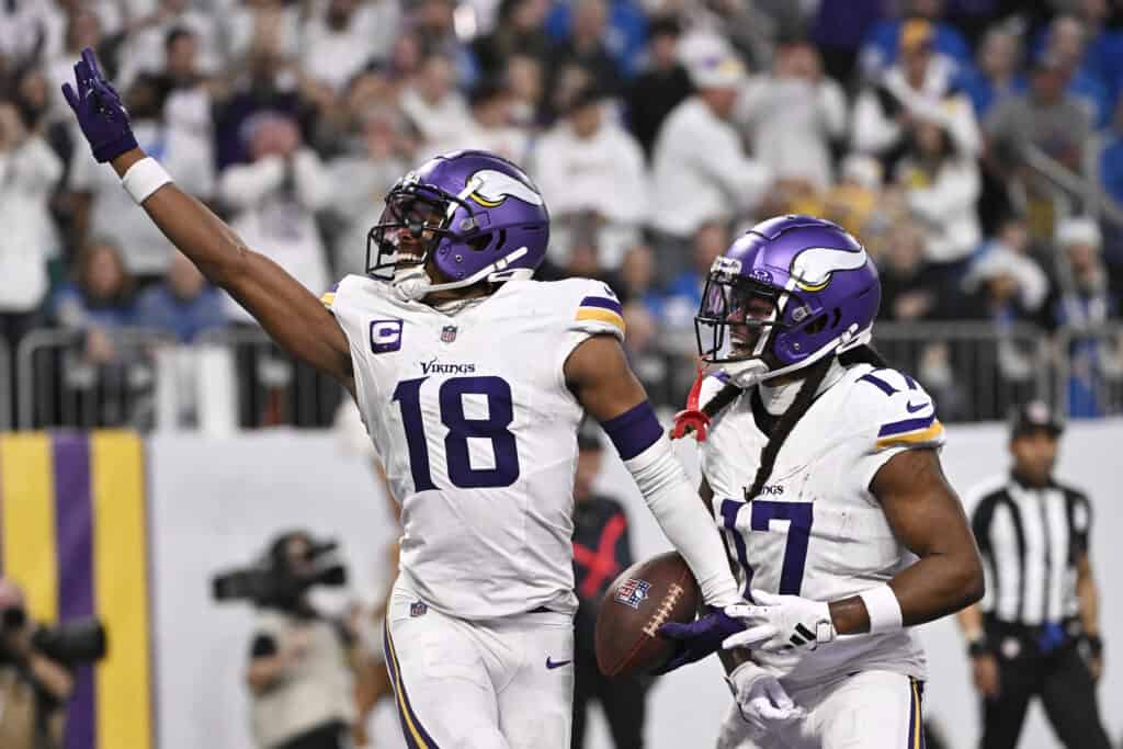 MINNEAPOLIS, MINNESOTA - DECEMBER 24:  Justin Jefferson #18 of the Minnesota Vikings is congratulated by K.J. Osborn #17 after scoring a touchdown reception against the Detroit Lions during the second quarter at U.S. Bank Stadium on December 24, 2023 in Minneapolis, Minnesota.