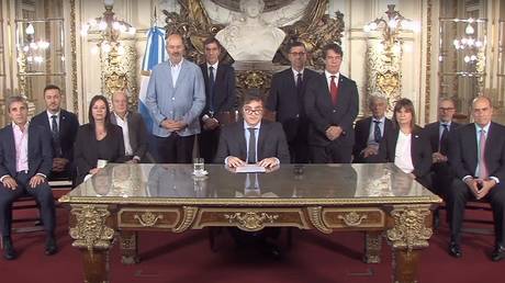 President Javier Milei (C) delivering a message to the nation from the Casa Rosada presidential palace in Buenos Aires on December 20, 2023.
