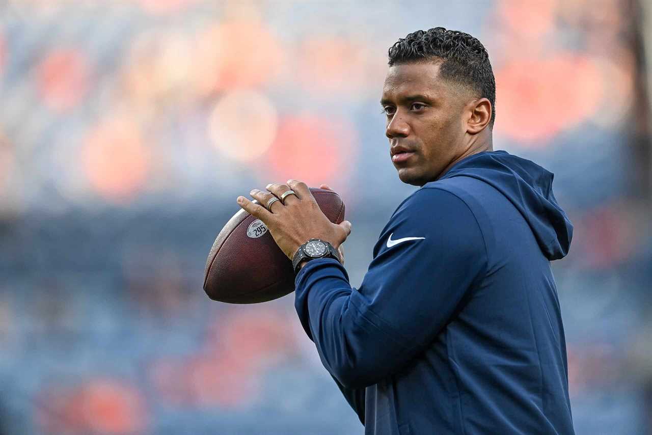 Quarterback Russell Wilson of the Denver Broncos throws as players warm up before a preseason game against the Los Angeles Rams at Empower Field at Mile High on August 26, 2023 in Denver, Colorado.