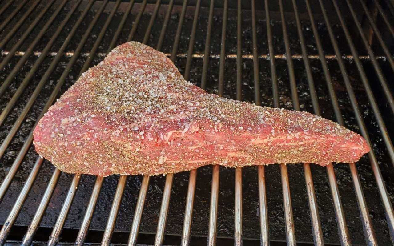 Raw beef roast on grill