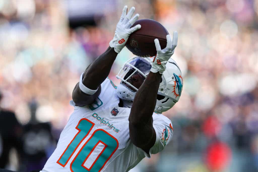 BALTIMORE, MARYLAND - DECEMBER 31: Tyreek Hill #10 of the Miami Dolphins catches a pass against the Baltimore Ravens during the second quarter at M&T Bank Stadium on December 31, 2023 in Baltimore, Maryland. 