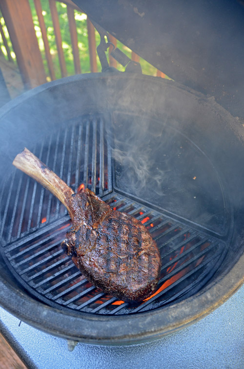 Tomahawk on Craycort cast iron grate on a big green egg kamado grill