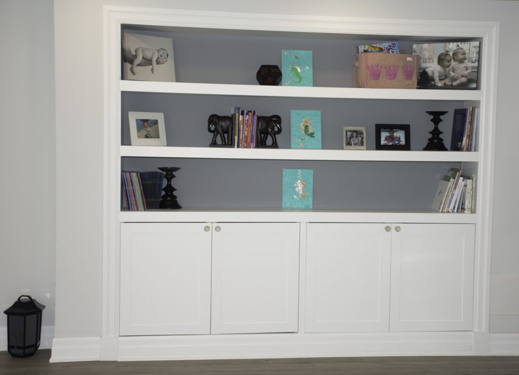 white-bookcase-shelf unit in a basement