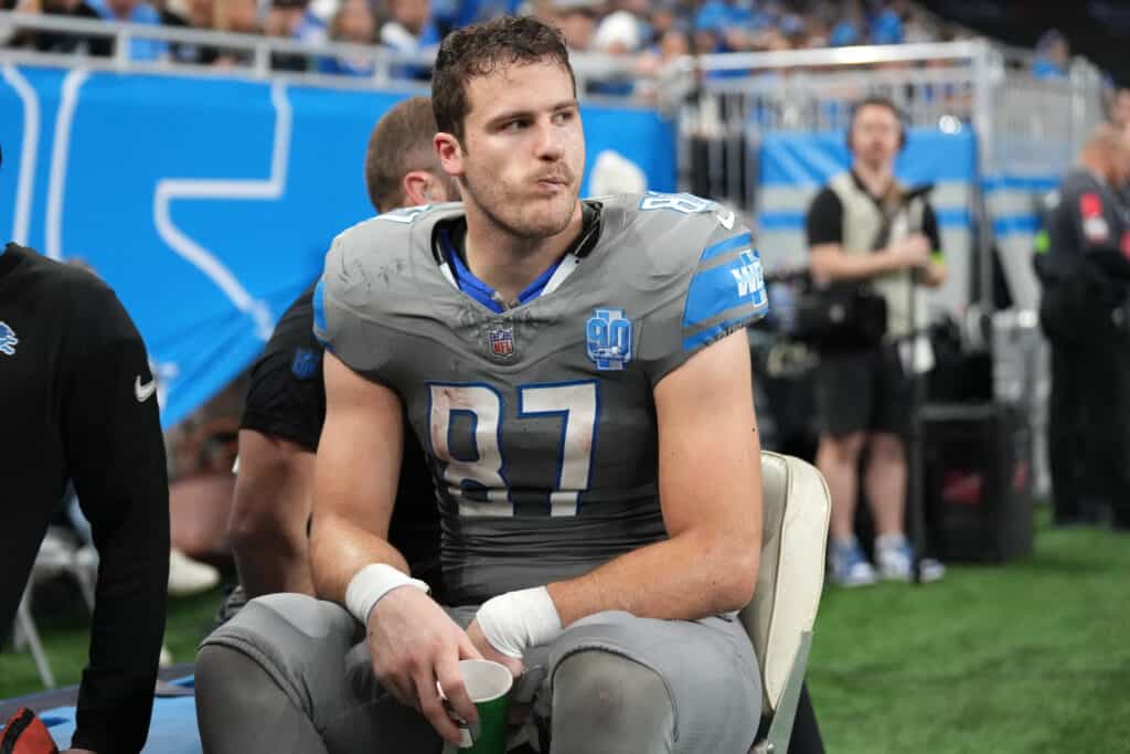 DETROIT, MICHIGAN - JANUARY 07: Sam LaPorta #87 of the Detroit Lions is taken off the field during the first half in the game against the Minnesota Vikings at Ford Field on January 07, 2024 in Detroit, Michigan. 