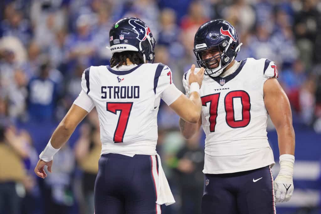 C.J. Stroud #7 and Juice Scruggs #70 of the Houston Texans celebrate a touchdown pass during the second quarter against the Indianapolis Colts at Lucas Oil Stadium on January 06, 2024 in Indianapolis, Indiana.