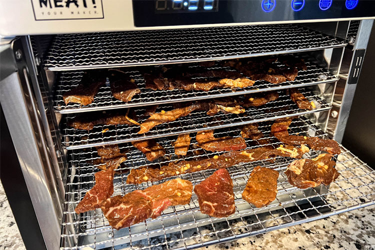 racks of jerky in the dehydrator