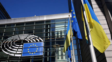 The Ukrainian flag flutters along side the European Union flag outside the European Parliament headquarters.