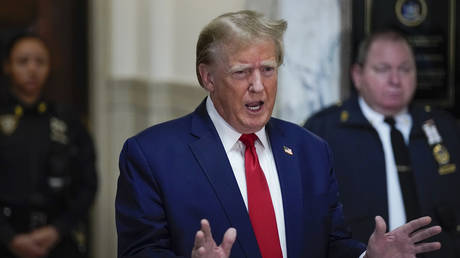 Former US President Donald Trump speaks after arriving for his civil business fraud trial in New York State Supreme Court on December 7, 2023 in New York City