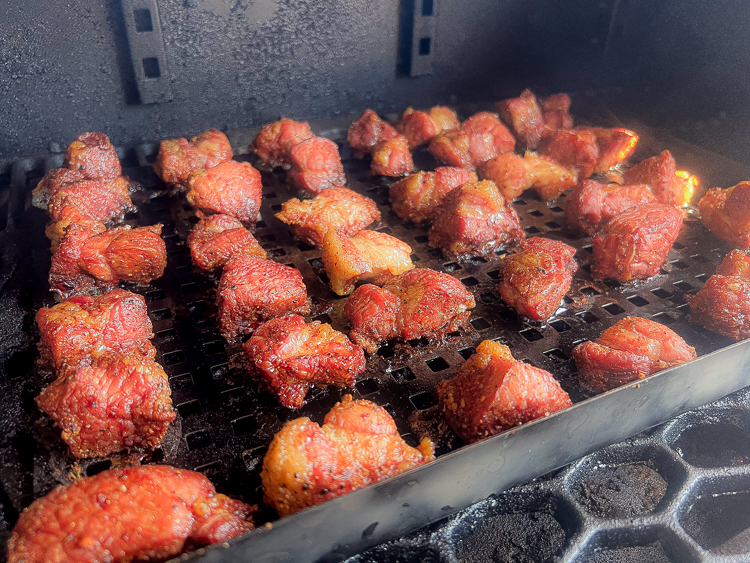 cooked cubed pork in the smoker