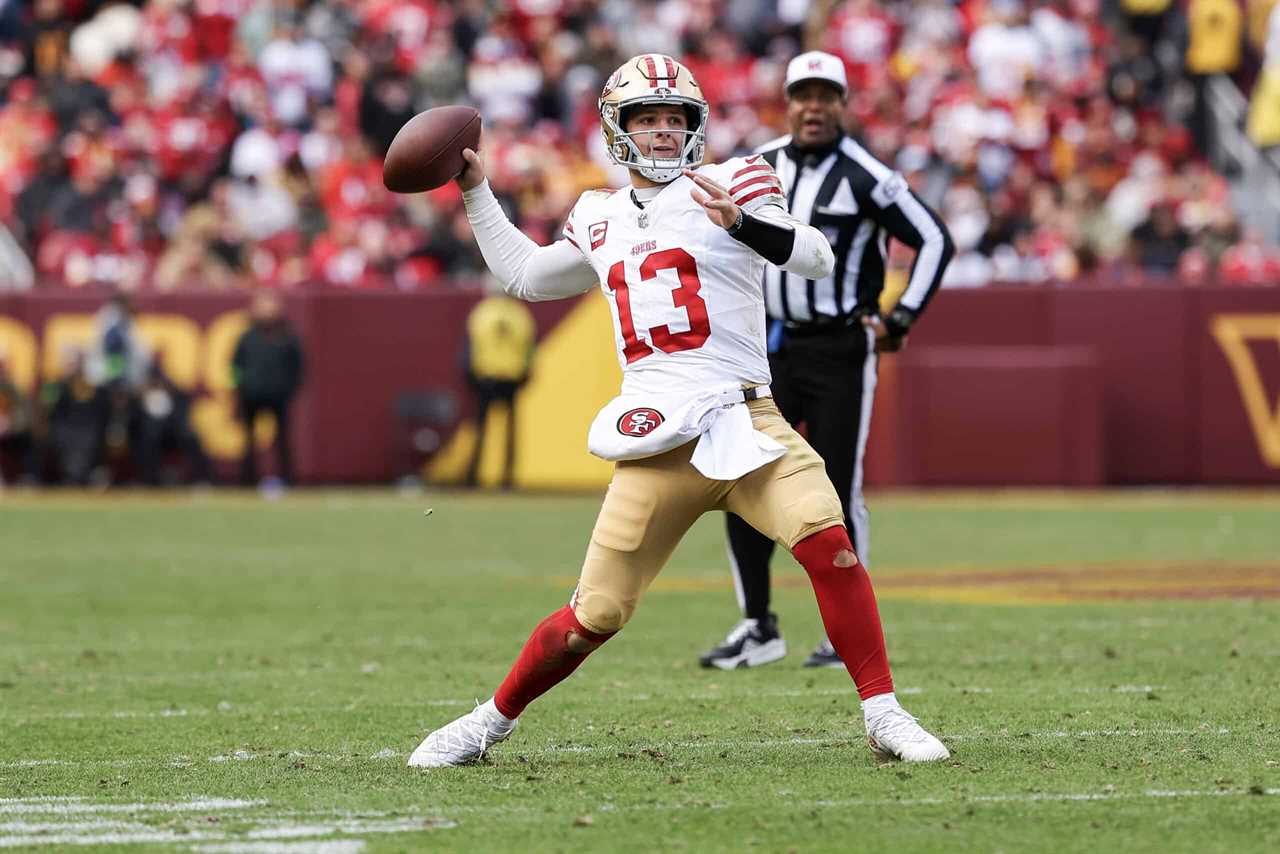 LANDOVER, MARYLAND - DECEMBER 31: Brock Purdy #13 of the San Francisco 49ers throws a touchdown during the fourth quarter of a game against the Washington Commanders at FedExField on December 31, 2023 in Landover, Maryland.