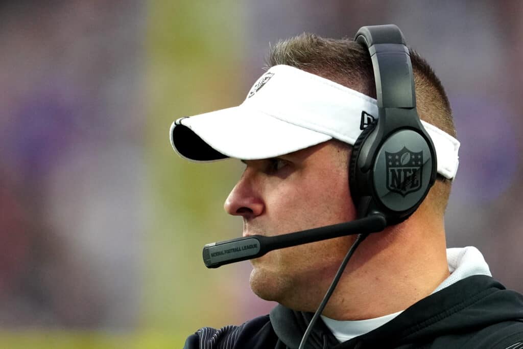 Head coach Josh McDaniels of the Las Vegas Raiders look on against the New England Patriots during the first half of the game at Allegiant Stadium on December 18, 2022 in Las Vegas, Nevada.