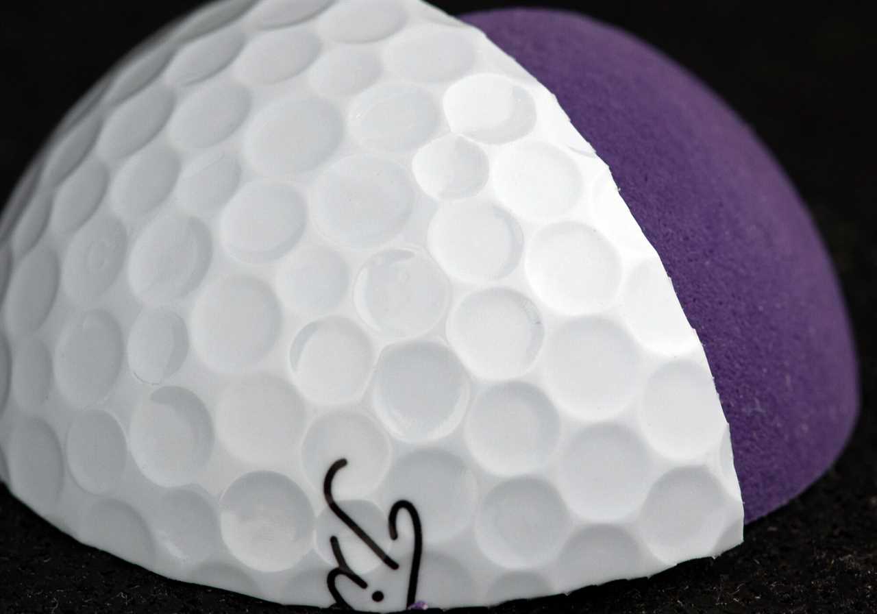 A closeup of the cover of a Titleist AVX golf ba..