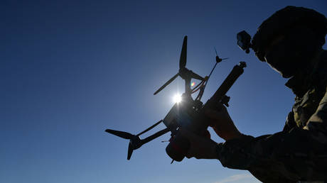 FILE PHOTO: A scout of the Russian Army Novorossiysk mountain air assault unit launches an FPV drone in the course of Russia's military operation in Ukraine.