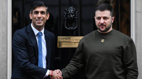 Ukraine's President Volodymyr Zelensky (R) shakes hands with Britain's Prime Minister Rishi Sunak.