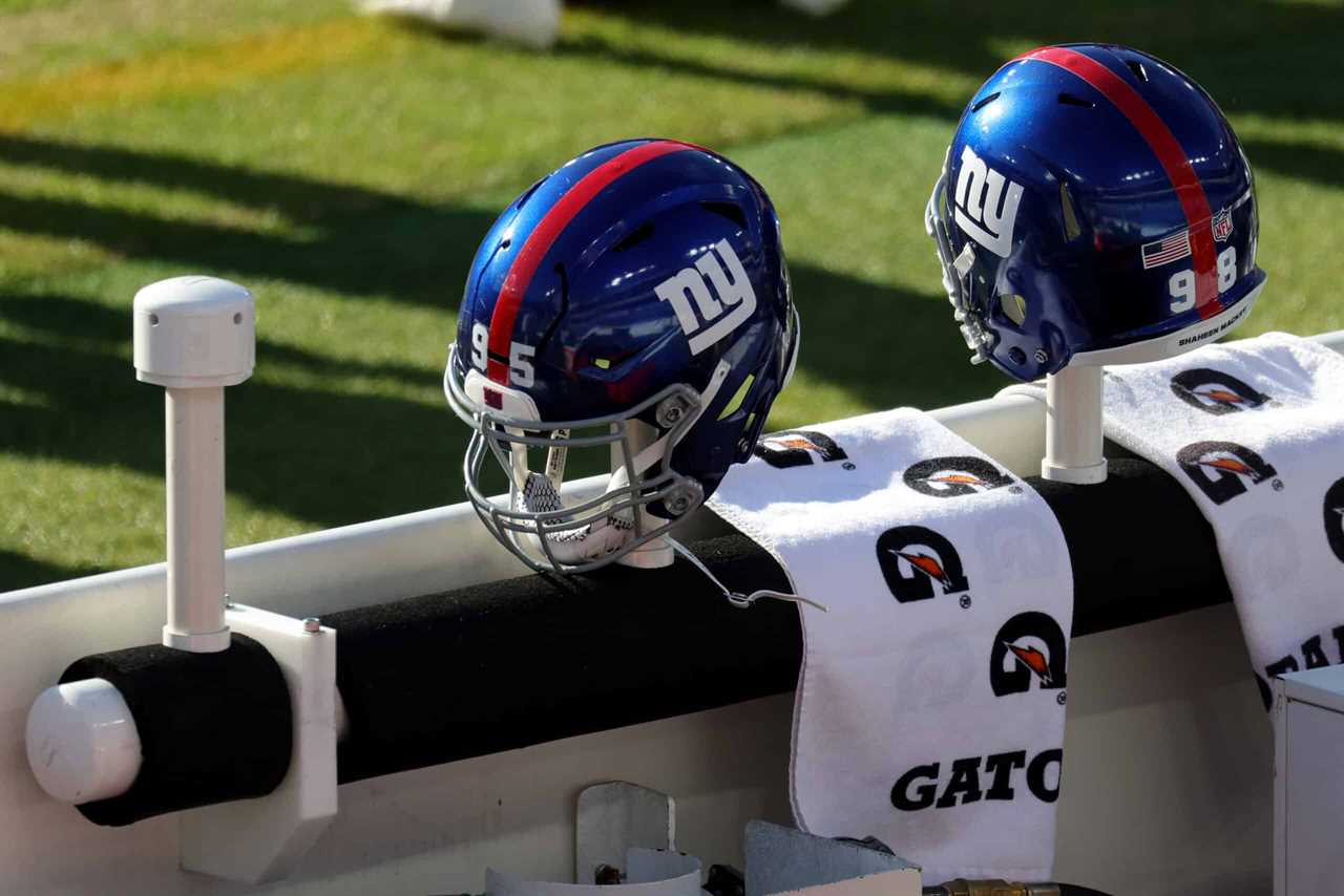 The helmets of B.J. Hill #95 and Austin Johnson #98 of the New York Giants , sit on the bench prior to the start of the Giants and Baltimore Ravens game at M&T Bank Stadium on December 27, 2020 in Baltimore, Maryland.