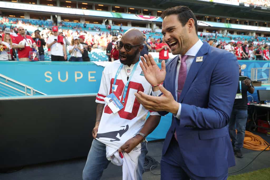 Former player Jerry Lee Rice Sr talks to former player Mark Sanchez before Super Bowl LIV between Kansas City Chiefs and San Francisco 49ers at Hard Rock Stadium on February 02, 2020 in Miami, Florida.