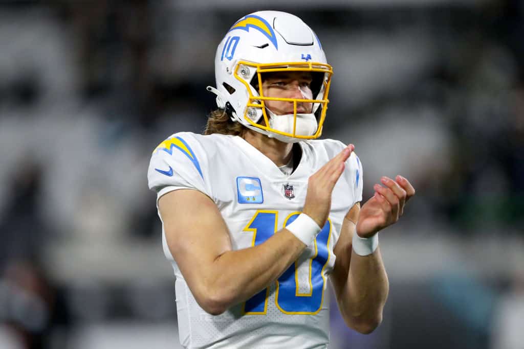 Justin Herbert #10 of the Los Angeles Chargers warms up prior to a game against the Jacksonville Jaguars in the AFC Wild Card playoff game at TIAA Bank Field on January 14, 2023 in Jacksonville, Florida.