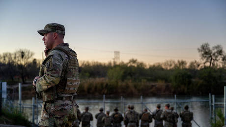 National Guard soldiers stand guard on the banks of the Rio Grande river at Shelby Park on January 12, 2024 in Eagle Pass, Texas.