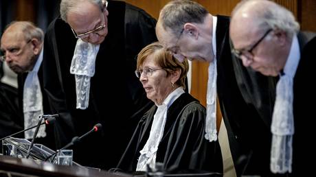 ICJ President Joan Donoghue (C) and ICJ judges arrive at the International Court of Justice (ICJ) prior to the verdict announcement in the genocide case against Israel, brought by South Africa, in The Hague on January 26, 2024.