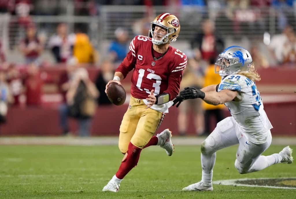 Brock Purdy #13 of the San Francisco 49ers avoids a tackle by Alex Anzalone #34 of the Detroit Lions during the fourth quarter in the NFC Championship Game at Levi's Stadium on January 28, 2024 in Santa Clara, California.