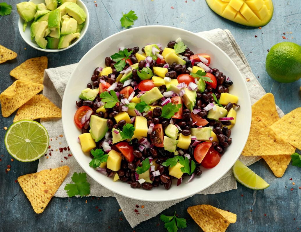 Texas Caviar in serving bowl with chips and garnish