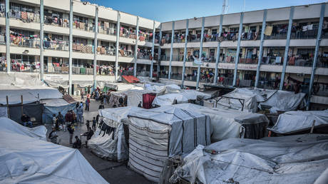 FILE PHOTO: Displaced Palestinians take shelter at an UNRWA school building in Rafah, Gaza, January 16, 2024