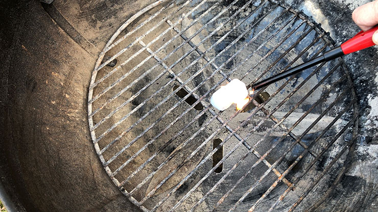 lighting wax cubes on a charcoal grill