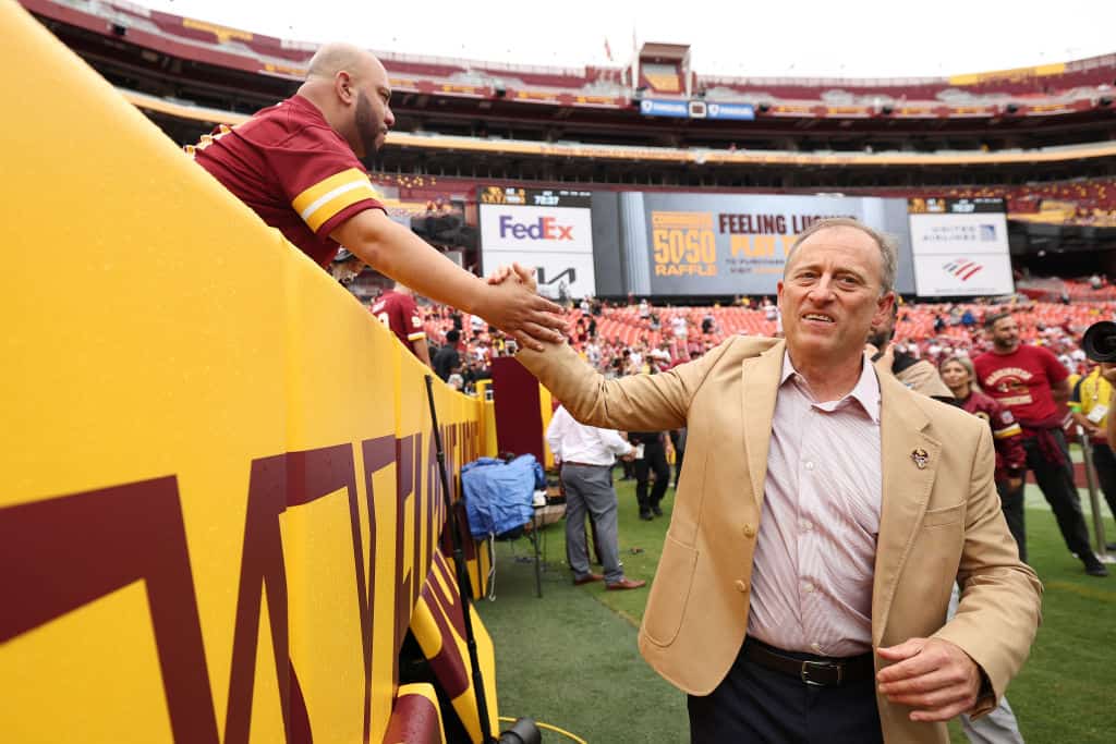 Washington Commanders owner Josh Harris high fives fans before his team's game against the Arizona Cardinals at FedExField on September 10, 2023 in Landover, Maryland.