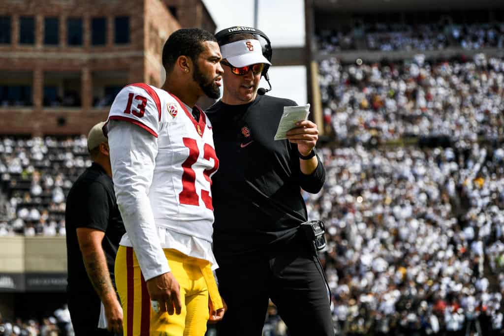 Head coach Lincoln Riley of the USC Trojans goes over the game plan with Caleb Williams #13 in the second half against the Colorado Buffaloes at Folsom Field on September 30, 2023 in Boulder, Colorado. 