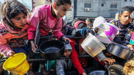 Children line up for food prepared for Palestinian families in Rafah, Gaza, on Friday.