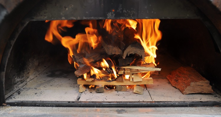 burning wood in a pizza oven