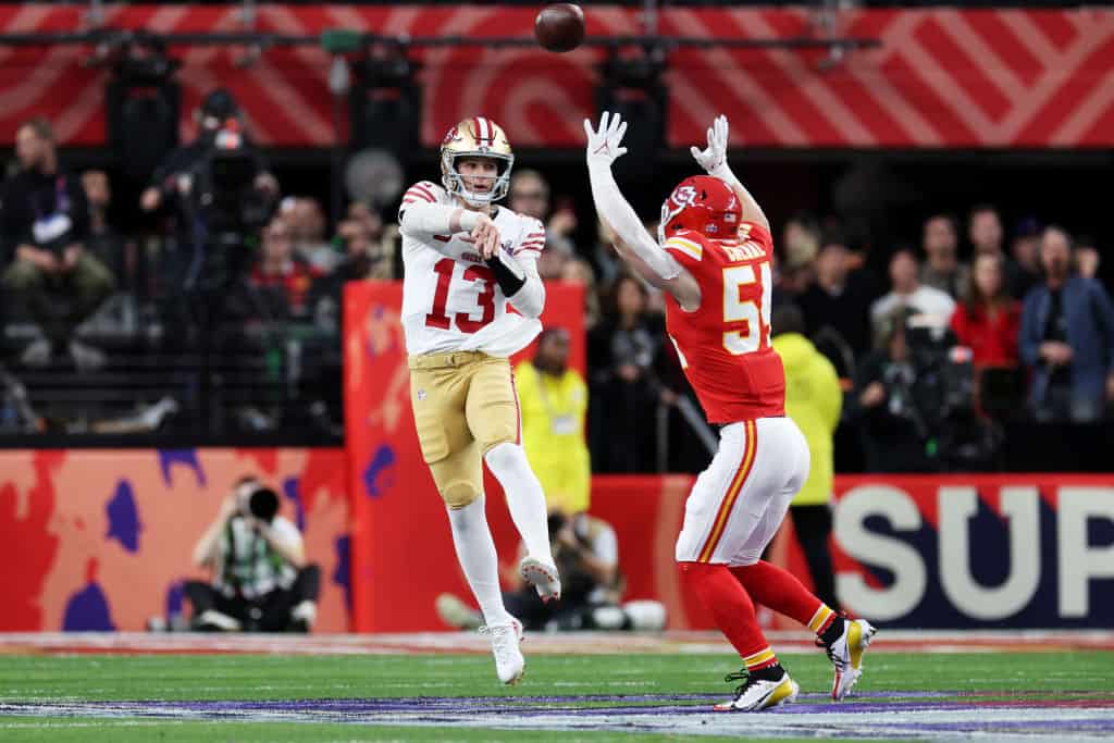 Brock Purdy #13 of the San Francisco 49ers throws a pass during the first quarter while defended by Leo Chenal #54 of the Kansas City Chiefs during Super Bowl LVIII at Allegiant Stadium on February 11, 2024 in Las Vegas, Nevada.