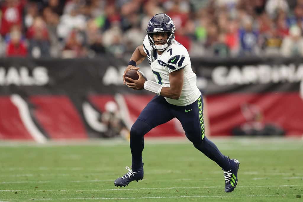 Quarterback Geno Smith #7 of the Seattle Seahawks runs with the football during the first half of the NFL game at State Farm Stadium on January 07, 2024 in Glendale, Arizona.