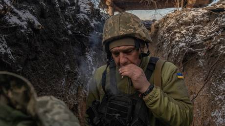 A Ukrainian soldier of the 41st brigade walks in a trench near the frontline, outside Kupiansk, Kharkov Region, on January 23, 2024.