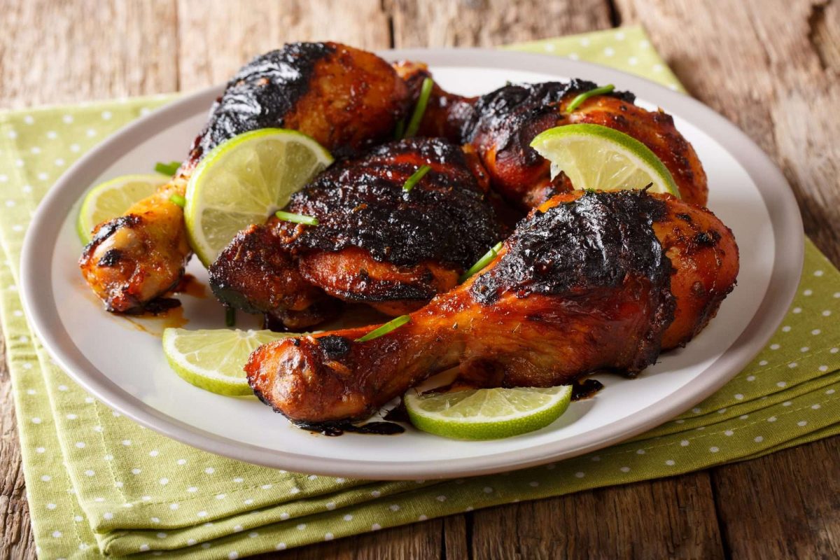Jamaican Jerk Chicken on a plate with lime slices