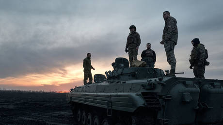 Ukrainian soldiers stand at the outskirts of Avdeevka last week as Russian forces advance on the city.