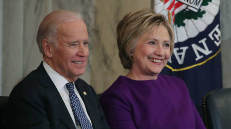 Former US Secretary of State, Hillary Clinton shares a laugh with Joe Biden, during a portrait unveiling ceremony for outgoing Senate Minority Leader Harry Reid (D-NV), on Capitol Hill December 8, 2016 in Washington, DC